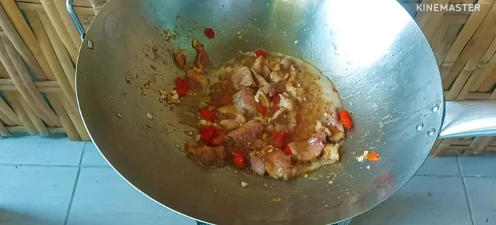 Add the onions, long beans, and basil leaves. Stir-fry over high heat until vegetables are cooked and basil is wilted.