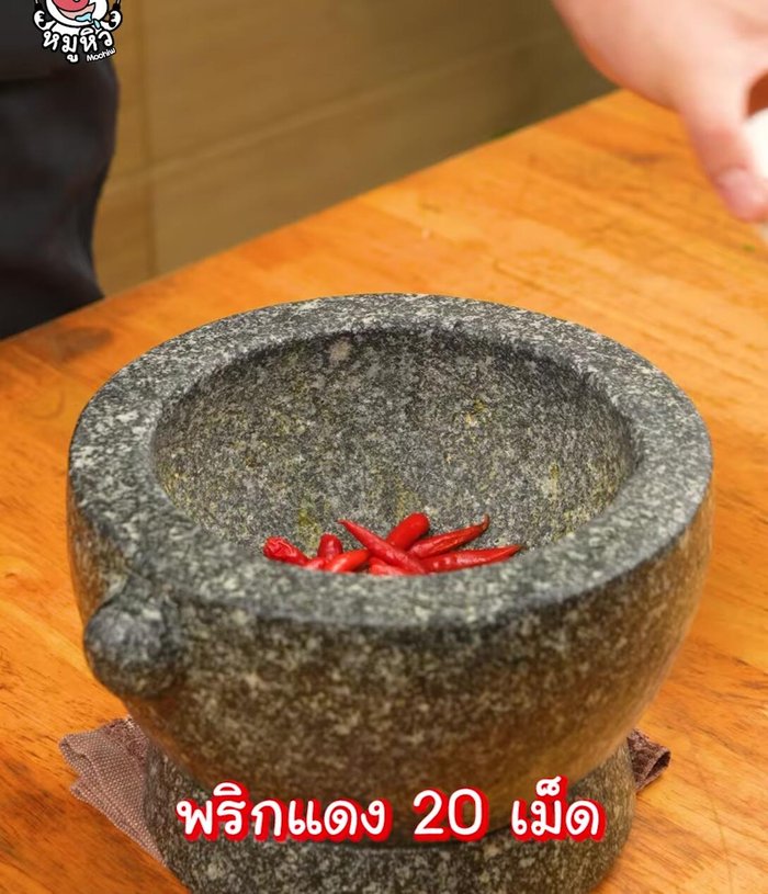 Pound the chilies: Pound the red chili peppers coarsely using a mortar and pestle (102.92).