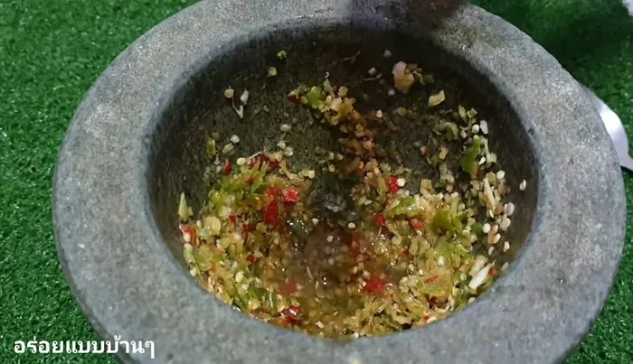 Add fish sauce, freshly squeezed lemon juice, and sugar to the pounded mixture.