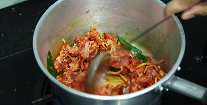 Stir-fry until the pork starts to cook. Add water.