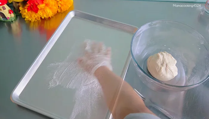 Sprinkle glutinous rice flour on a tray.