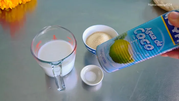 Prepare the coconut milk mixture: Combine coconut milk, coconut water, sugar, and salt. Simmer until heated.