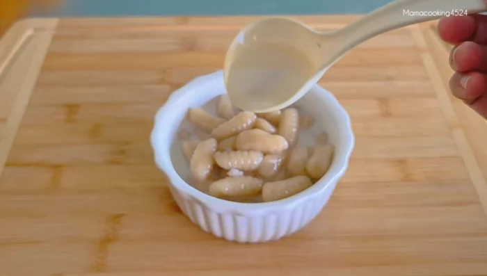 Serve the Banana Canals warm with the coconut milk and sesame seeds.
