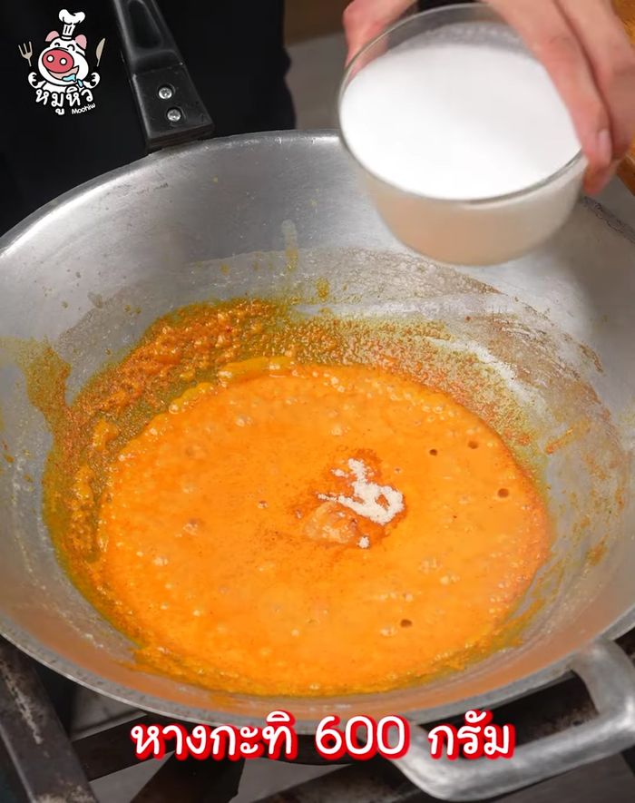 Add seasoning powder and coconut milk, then water. Mix well.