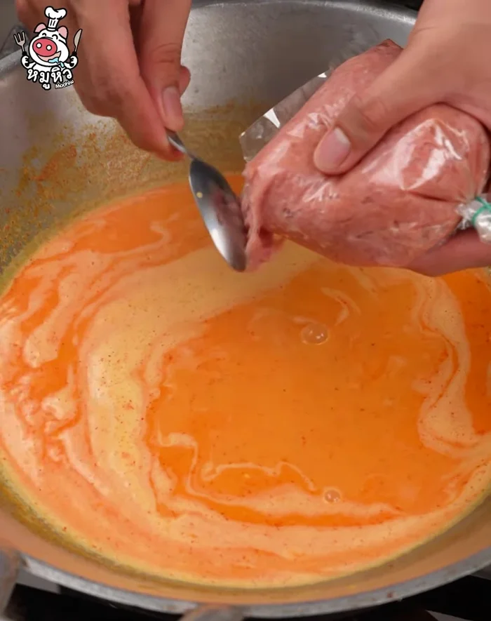 Add the marinated pork, chili, and lime leaves. Stir to combine.