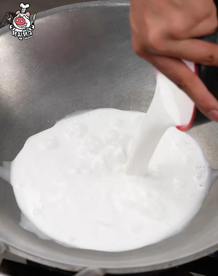 In a pan, stir in coconut milk to add flavor.