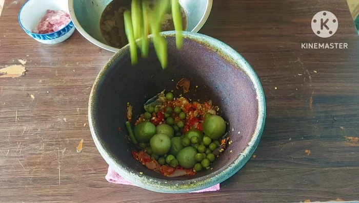 Pound the cooked vegetables to create a smoother consistency.