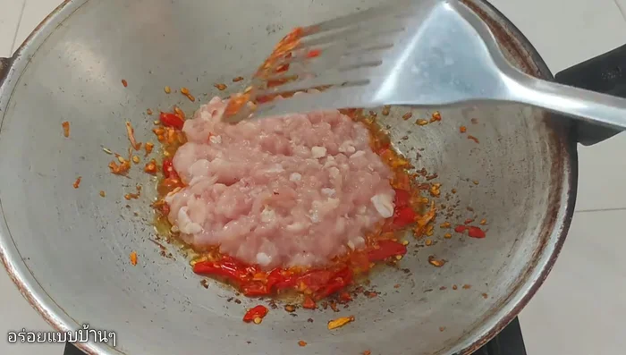 Add minced chicken and stir-fry until cooked.