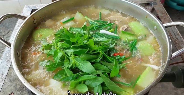 Add spring onions, betel leaves, and more chili peppers for garnish.
