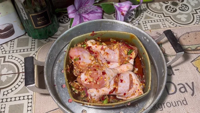 Steam the chicken: Place the marinated chicken legs in a steamer and steam over a charcoal stove (or other heat source) for about 30 minutes, or until cooked through.