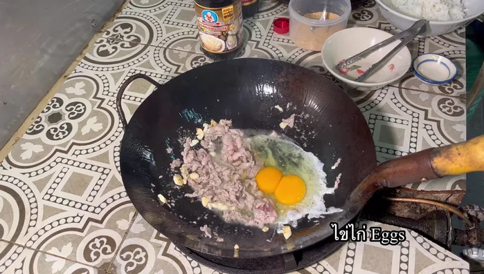 Add eggs, wait 1 minute, then spread them. Add cooked jasmine rice and stir-fry until well combined.
