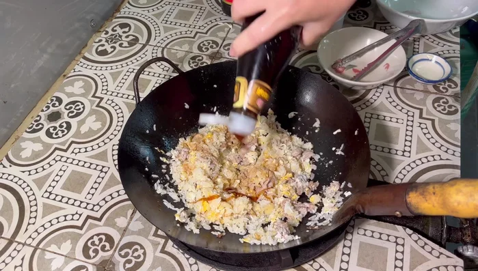 Add fried rice powder, oyster sauce, and dark soy sauce. Stir-fry well.
