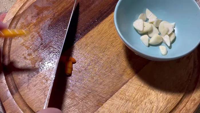 Make chili sauce: Chop Chinese garlic and Karen chili. Add lemon juice (to prevent browning), brown sugar, and let it sit for 2 minutes. Then add fish sauce.