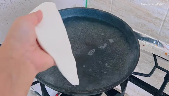 Immediately transfer the boiled dough to cold water.