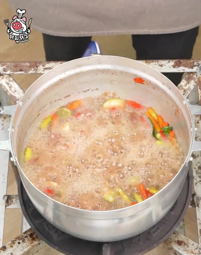 Continue boiling until the eggplant is cooked. Add stir-fried vegetables, betel leaves, coriander leaves, spring onions, and coriander.