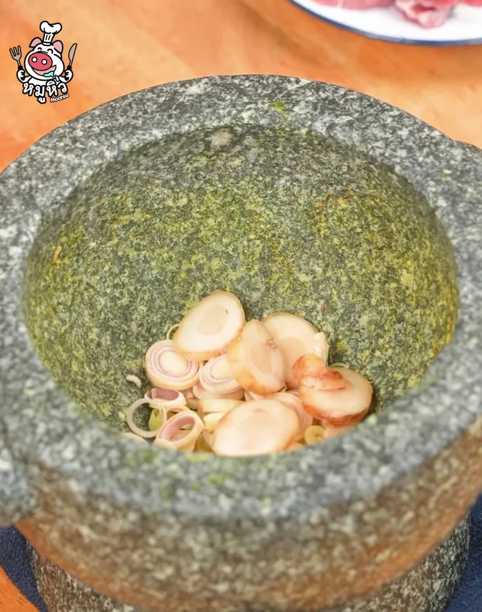 Pound lemongrass, chili, garlic, and shallots in a mortar until coarsely chopped.