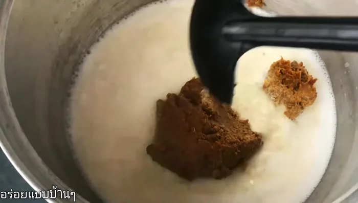 Add the curry paste to the coconut milk and stir until dissolved.