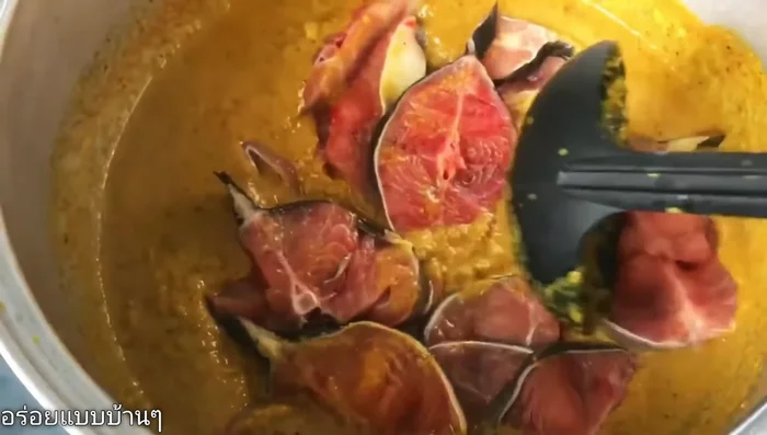 Add the catfish to the curry, cover the pot, and let it cook without stirring.
