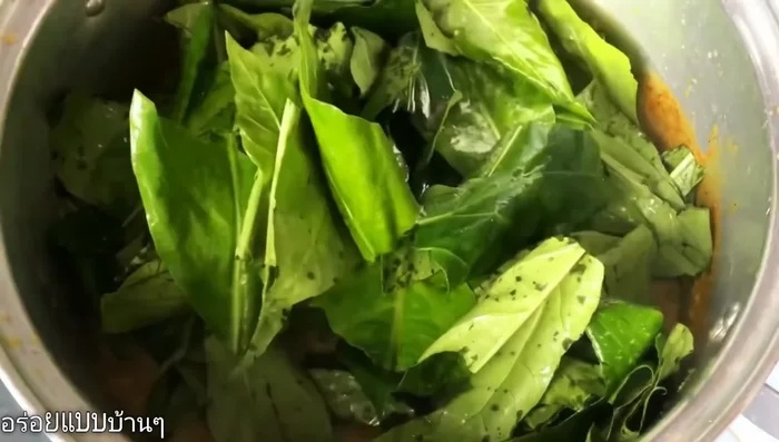 Add the betel leaves and Moringa leaves to the curry. Simmer until the leaves wilt.
