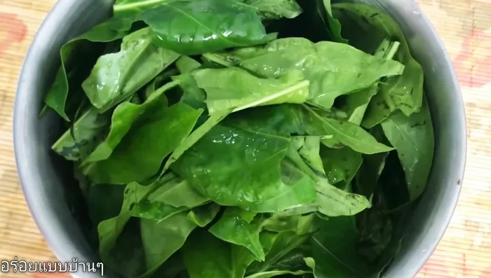 Prepare the Moringa leaves by tearing them into bite-sized pieces.