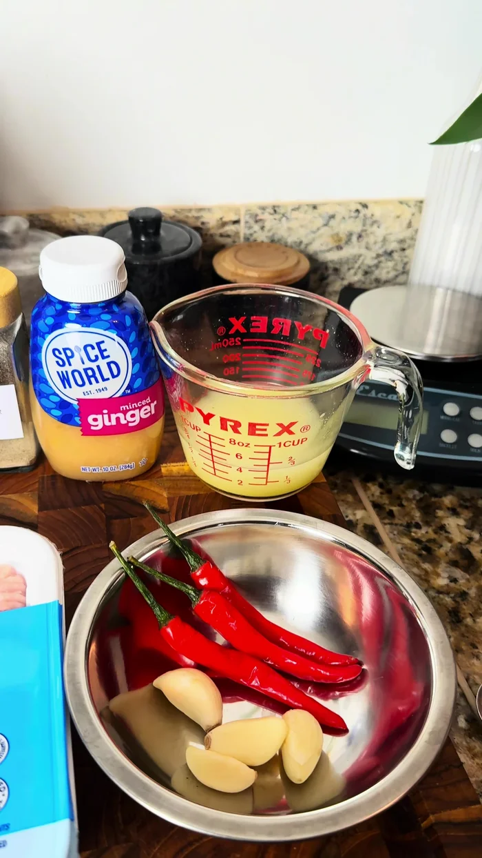 Make the sauce: In a cup, combine hot water, chicken base, sugar, soy sauce, fish sauce, oyster sauce, white pepper, and ginger. Stir until sugar dissolves.