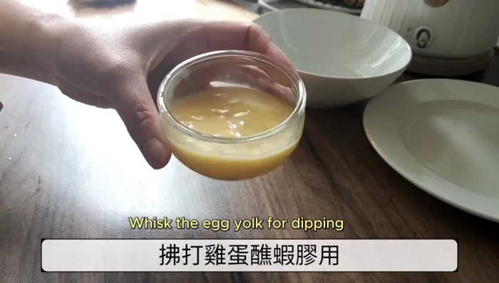 Whisk egg yolks for dipping. Prepare breadcrumbs.