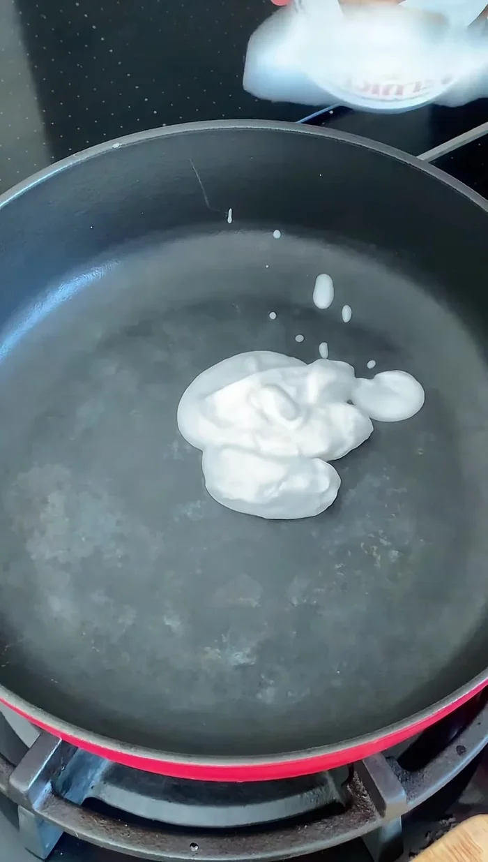 Add the thick part of the coconut milk to the pan.