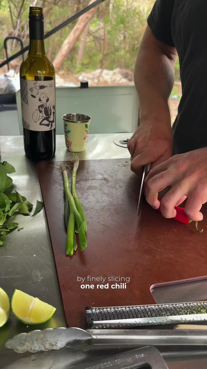 Prepare garnish: finely slice 1 red chili and chop some spring onions.