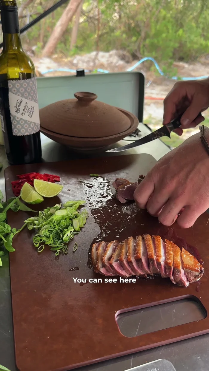 Slice the rested duck breasts thinly.