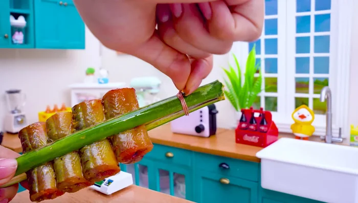 Prepare bamboo tubes for grilling, tying the ends with steel wire.