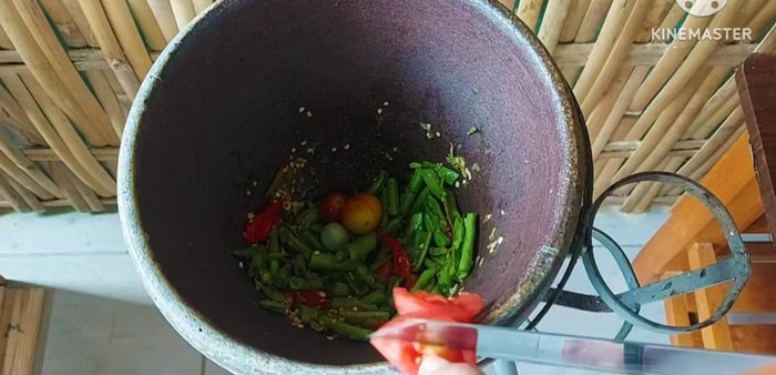 Add the fish sauce, fermented fish sauce, tamarind, and lemon juice. Season to taste.
