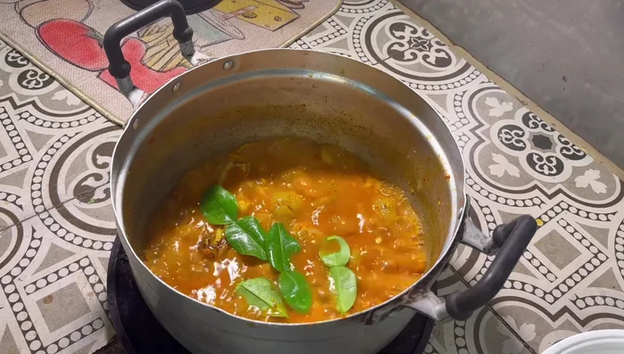 Add kaffir lime leaves, squeezing gently to release their aroma.