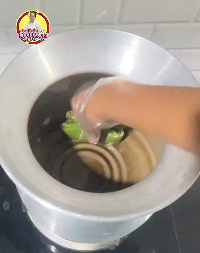 Steam or boil the Khao Tom Mat in a pot, ensuring the water covers the dumplings about 2 finger widths high. Cover with remaining banana leaves and use medium-high heat for about 40 minutes.