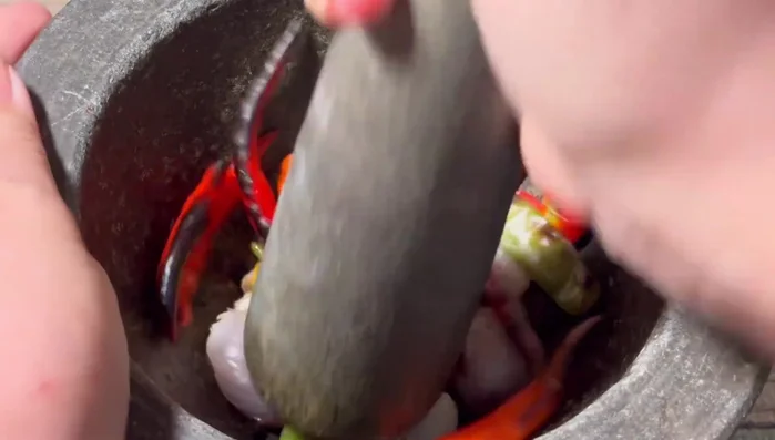Pound the grilled chili, onion, and garlic in a mortar and pestle to your desired consistency.