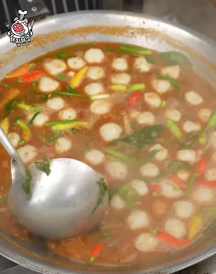 Add fish balls, chili peppers, and vegetables.