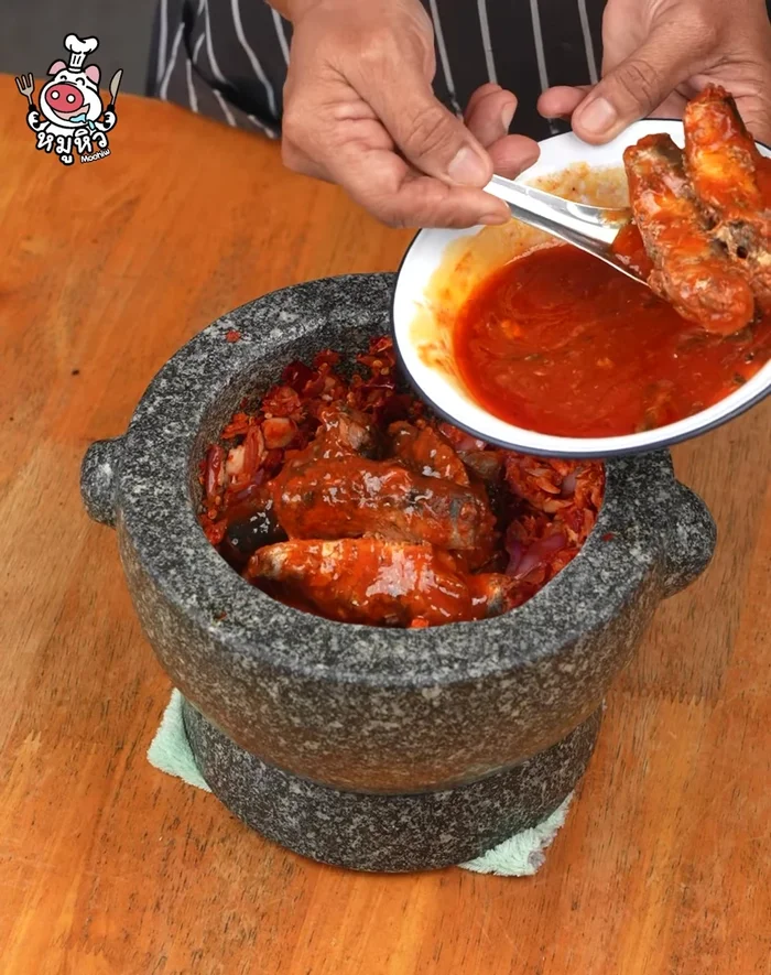 Add canned fish and pound until well mixed. Add fish sauce.