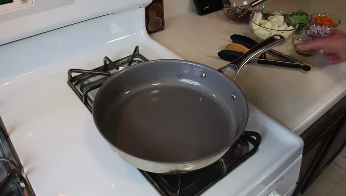 Heat olive oil in a pan over medium-high heat. Add diced onion and cook until softened.