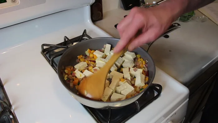Add the tofu to the pan, arranging it in a single layer. Cook until lightly browned on both sides.