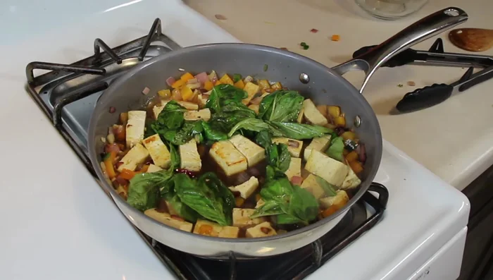 Cover the pan and let it simmer until the sauce thickens and the basil wilts.