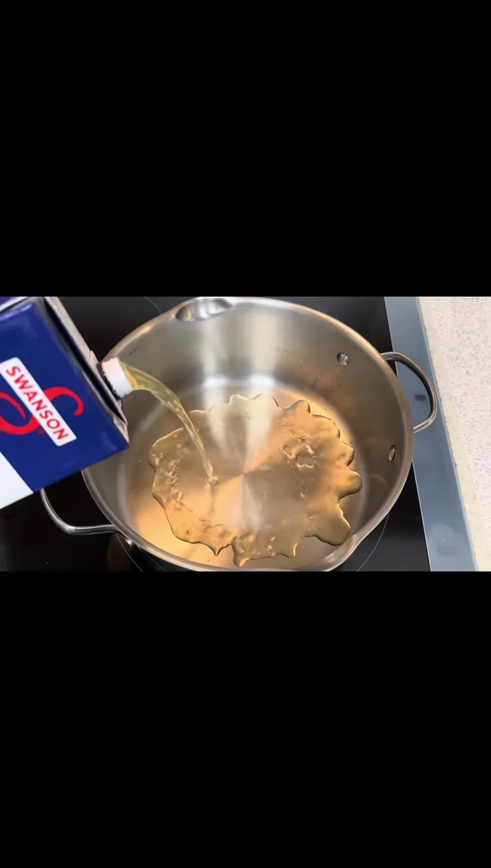 Add chicken broth and water to a pot. Add lemongrass and kafir lime leaves.