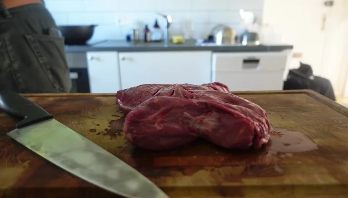 Prepare the hanger steak: Separate the two steaks by making a small incision and pulling them apart. Trim off excess fat and sinew. (100.439)