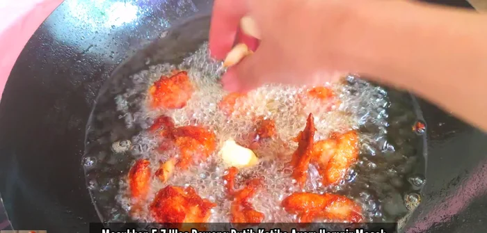 Towards the end of cooking, add 5-7 cloves of garlic to the pan and continue cooking until the chicken is fully cooked.