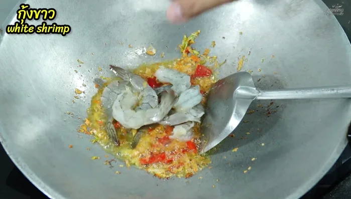 Add shrimp and squid to the wok and stir-fry briefly.