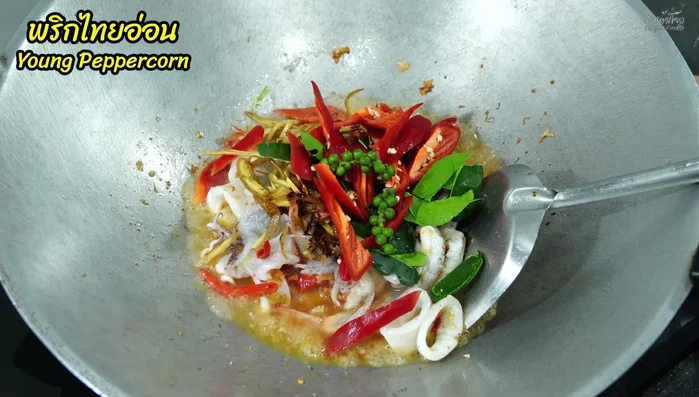 Add lime leaves and sliced chili peppers. Stir-fry until fragrant.