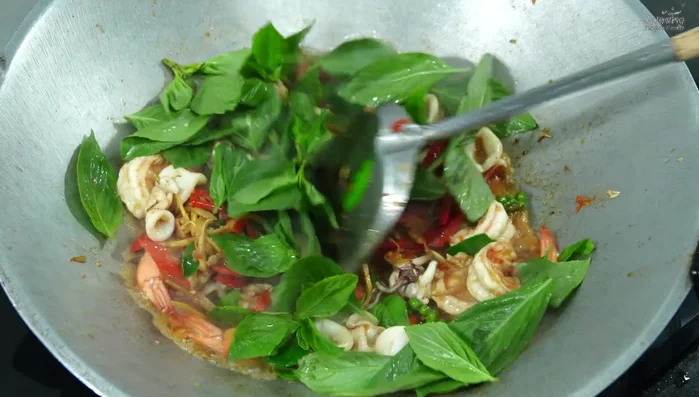 Add basil leaves and stir-fry until wilted.