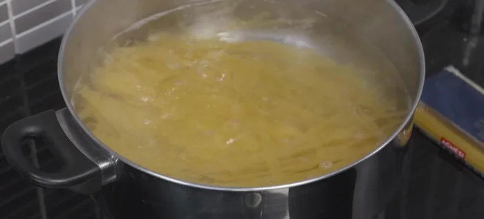 Drain the pasta and toss with a little vegetable or olive oil to prevent sticking.