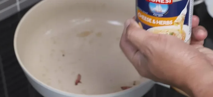 Add Acnesy Pastace Cheat and Herb sauce to the pan (with bacon fat). Heat over medium heat, adding a little water if needed to adjust consistency.