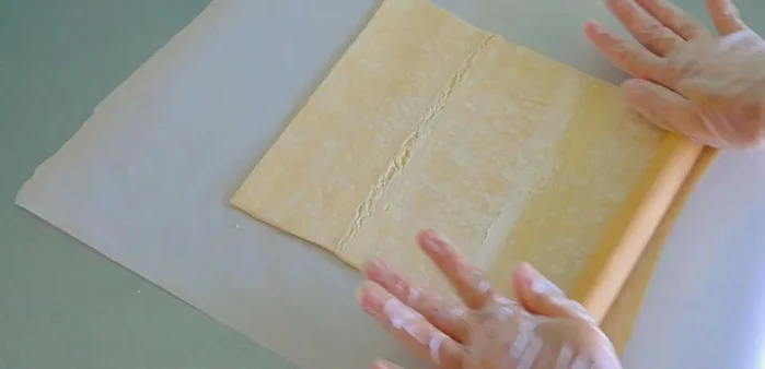 Roll out the puff pastry dough on a lightly floured surface.