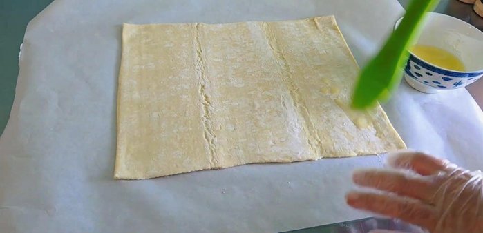Spread melted butter evenly over the pastry.