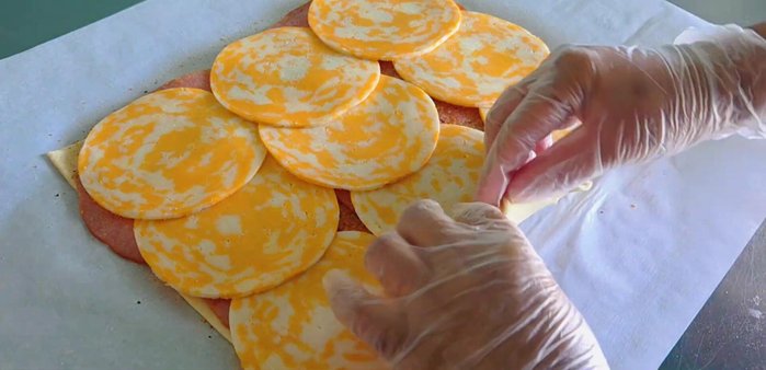 Tightly roll up the pastry and pinch the edges to seal.